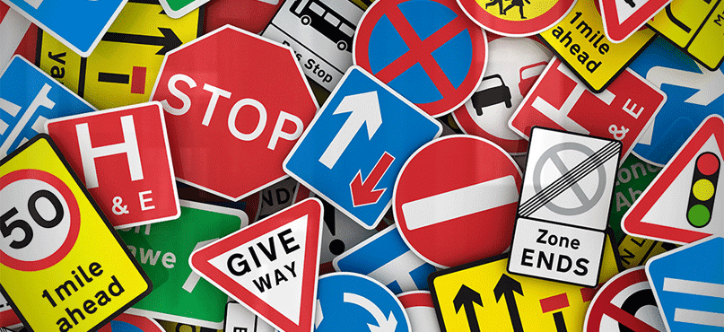 Compilation of lots of different road signs e.g. stop, give way, zone ends, hospital, traffic lights.