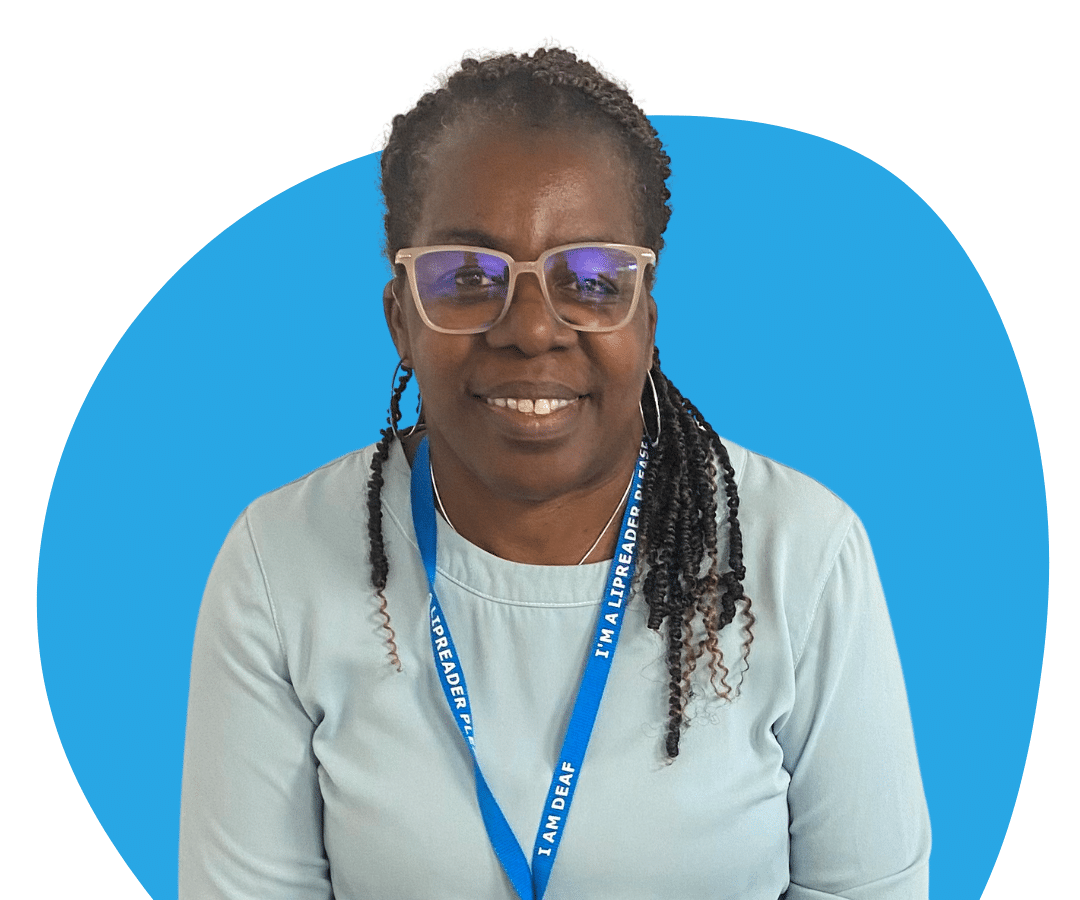 Black woman with long black hair and glasses against a light blue background.