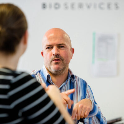 Lady and man facing each other having a conversation in sign language