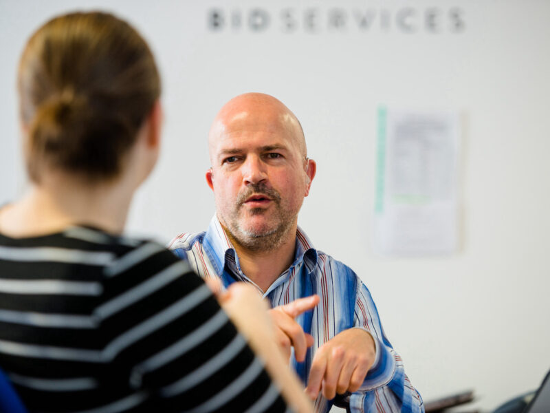 Lady and man facing each other having a conversation in sign language