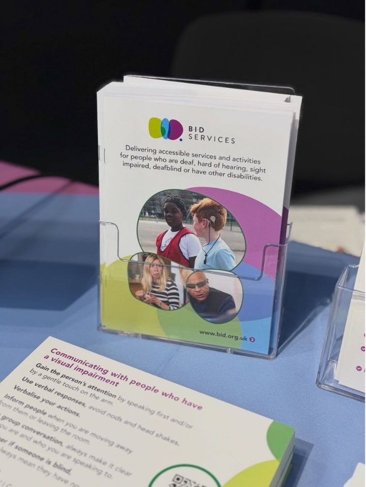 Close up of some general BID Branded portrait leaflets, presented in a clear acrylic stand.