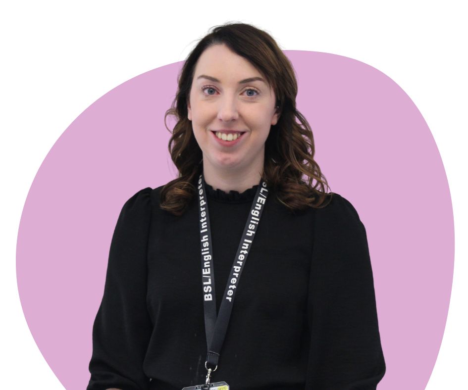 White woman with shoulder length brown hair against a purple background.