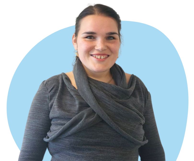 White woman with dark brown hair against a blue background.