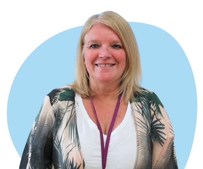 White woman with shoulder length blonde hair against a light blue background.