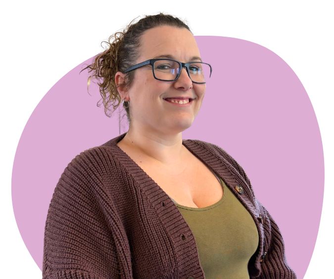 White woman with brown curly hair and glasses against a light purple background.