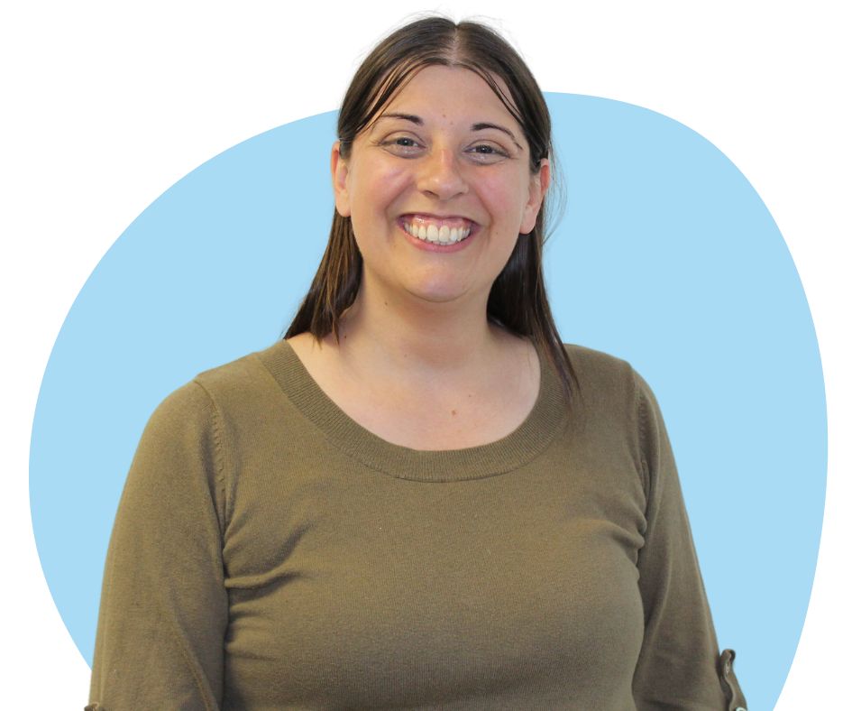 White woman with long dark hair against a blue background.