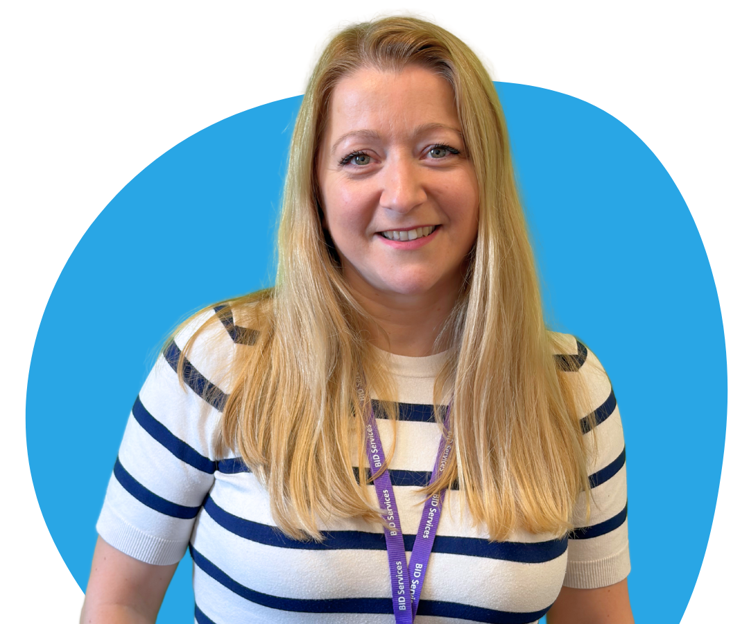 A white woman with long, straight blonde hair against a light blue background.