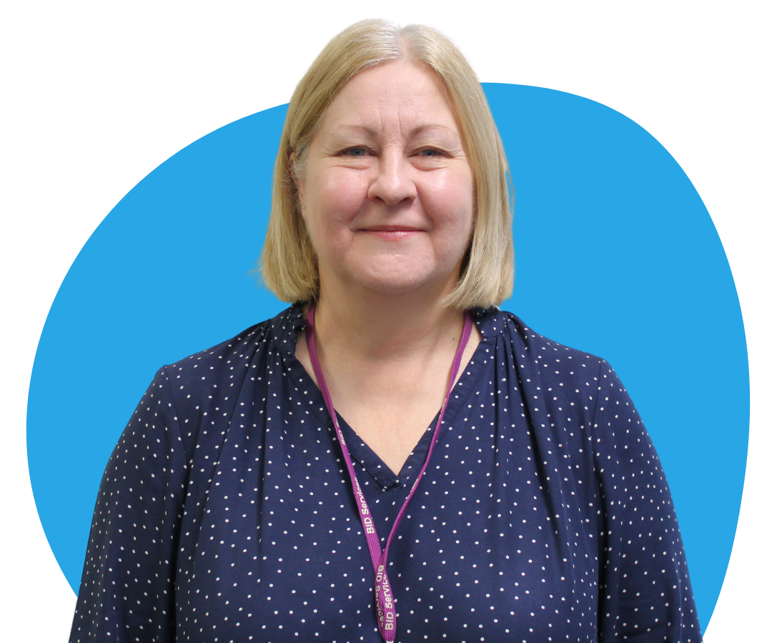 White woman with chin-length blonde hair against a light blue background.