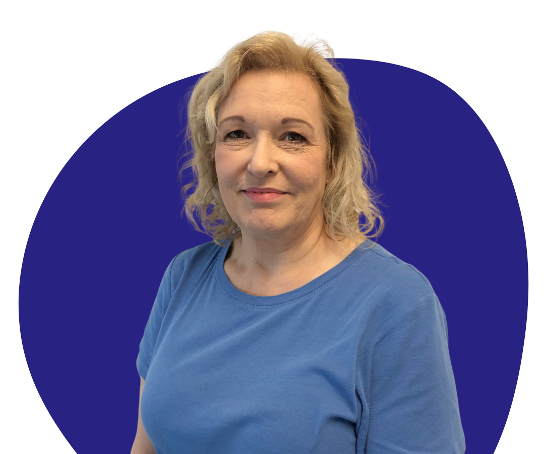 A white woman with shoulder length blonde hair against a dark blue background.
