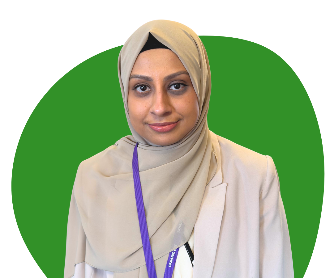 An Asian woman wearing a sari against a dark green background.