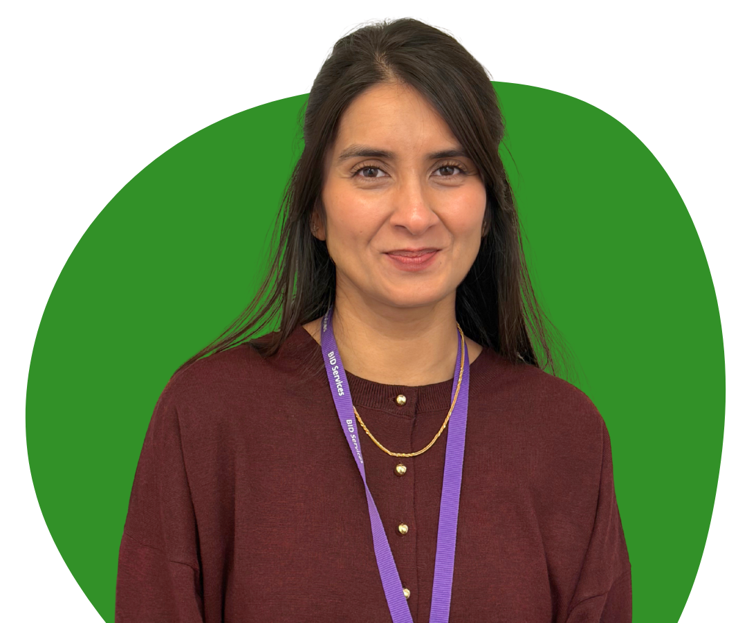 An Asian woman with long, black hair against a dark green background.