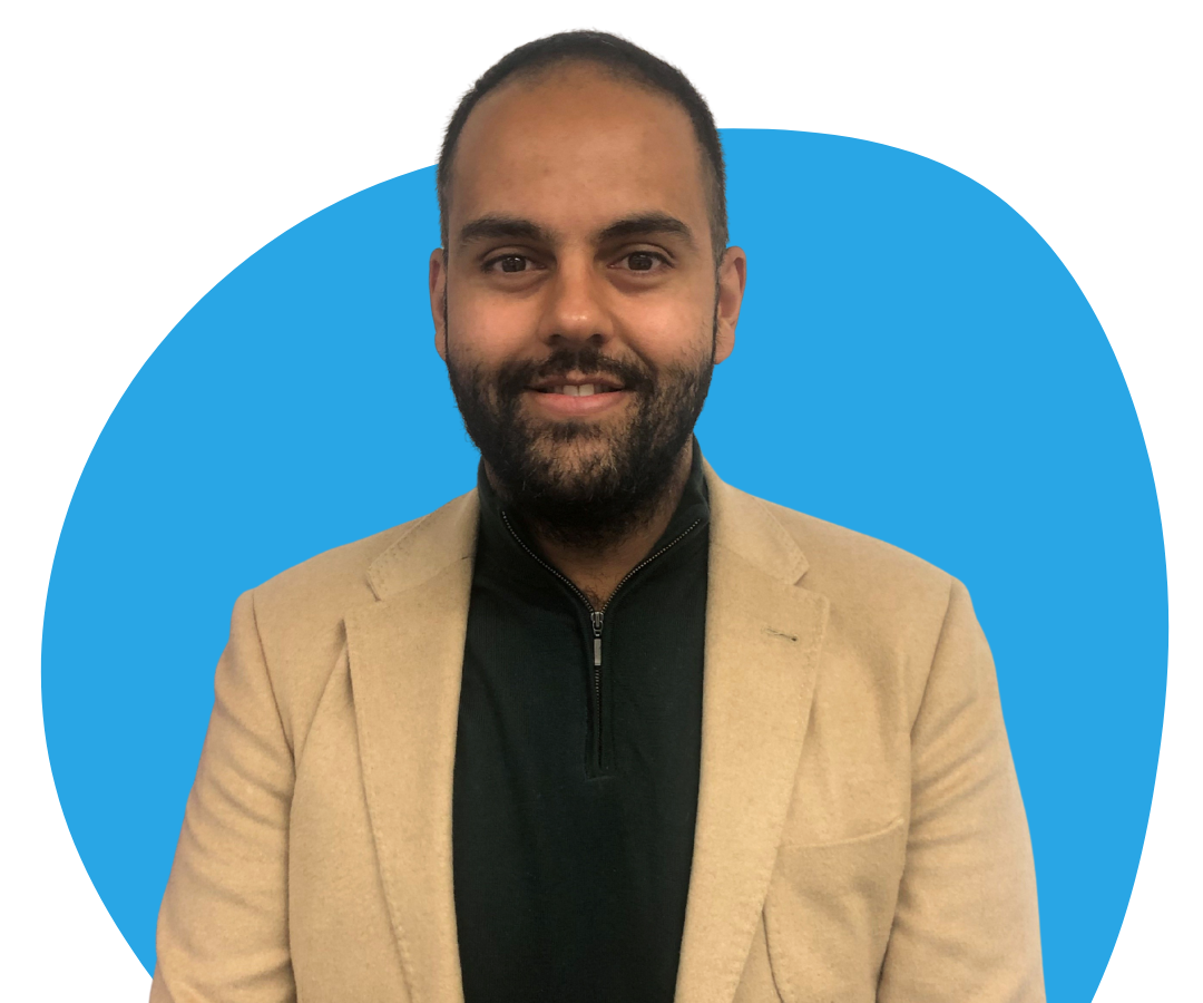 An Asian man with short black hair and a beard against a light blue background. 